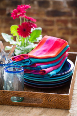 multicolored handwoven napkins and plates